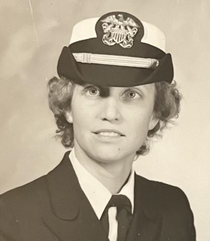 A woman in uniform wearing a hat and tie.